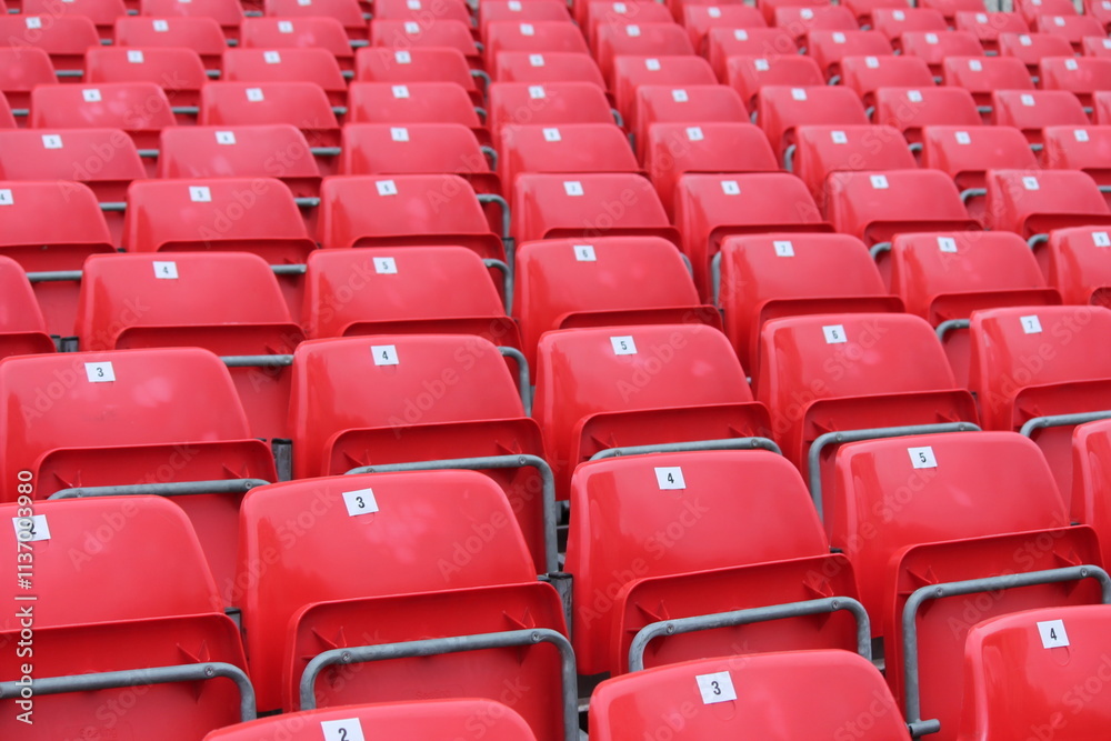 Empty red seats in stadium row in lines Empty red seats in stadium row in lines