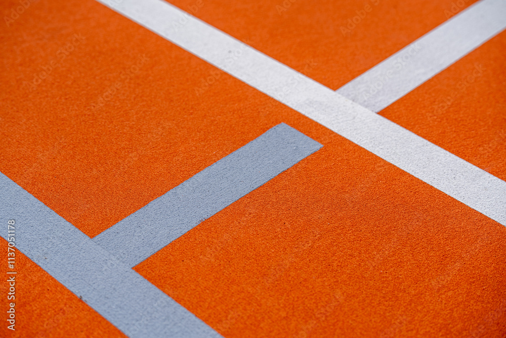 Fototapeta premium Orange and black tennis court - pickleball court with white lines and light gray pickleball lines 