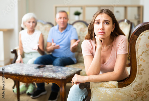 Sad upset or depressed portrait girl sitting on the sofa photo