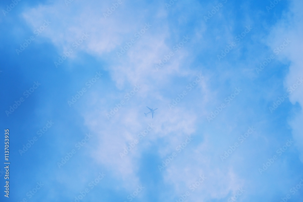 Airplane passing thru blue sky with clouds Airplane passing thru blue sky with clouds