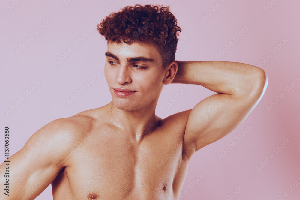 Confident young man posing against a pink background, showcasing his fitness and self-assurance. Strong emotions and body positivity concept. Confident young man posing against a pink background, showcasing his fitness and self-assurance. Strong emotions and body positivity concept.