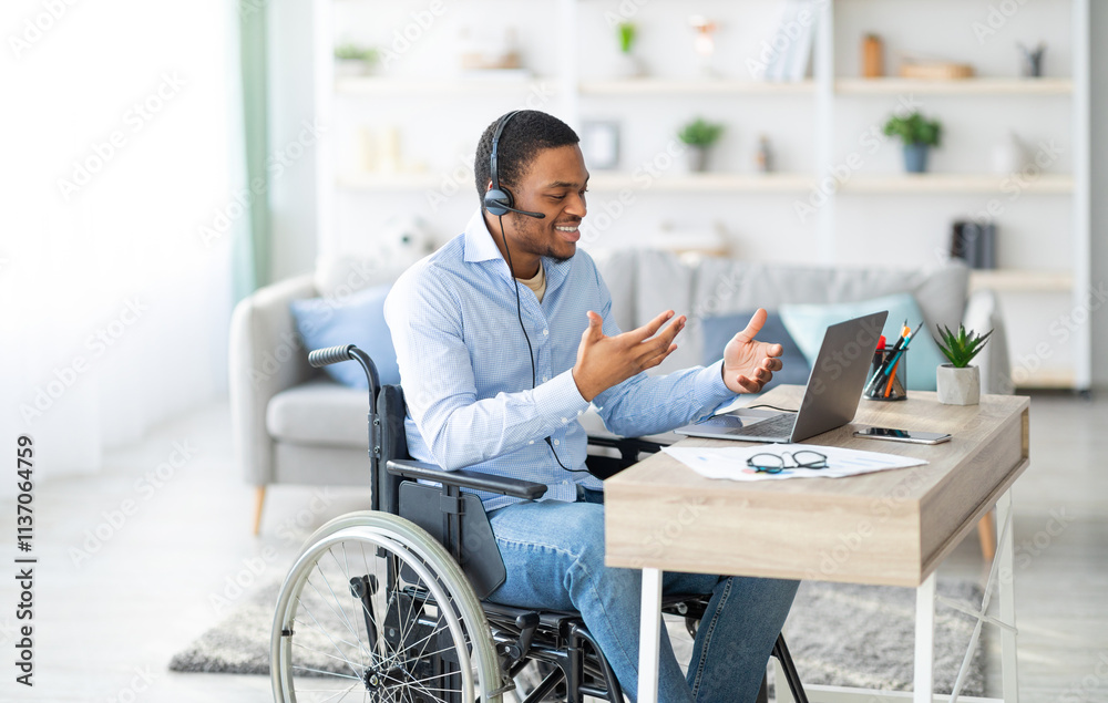 Disabled black guy with headset communicating online on laptop, having business meeting from home. Millennial African American man in wheelchair working in call centre remotely Disabled black guy with headset communicating online on laptop, having business meeting from home. Millennial African American man in wheelchair working in call centre remotely