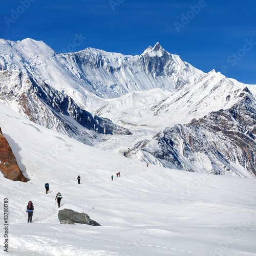 hikers on glacier and Mount Khangsar Kang photo