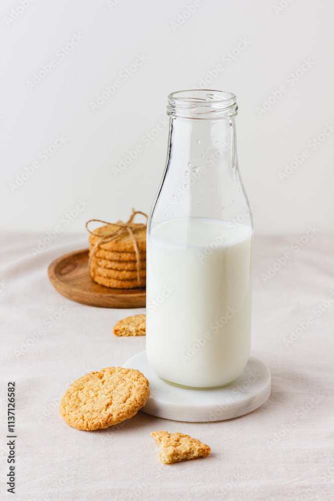 Bottle of fresh milk with oatmeal cookies Bottle of fresh milk with oatmeal cookies