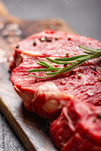 Raw beef meat on a wooden cutting board