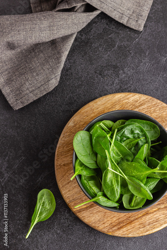 Fresh green spinach leaves in the bowl. Natural vegetarian food.