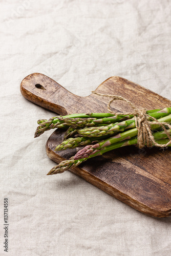 Green asparagus on a wooden cutting board