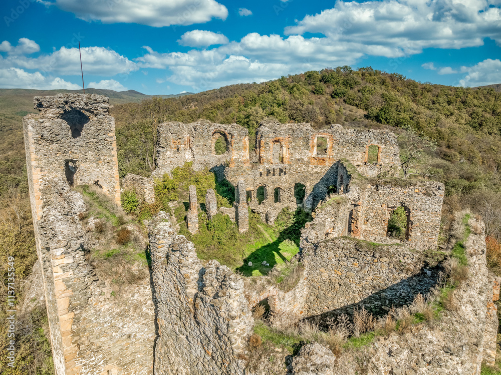 Fototapeta premium Aerial view of Soimos medieval castle in Romania near Lipova above the Mures river with Gothic details