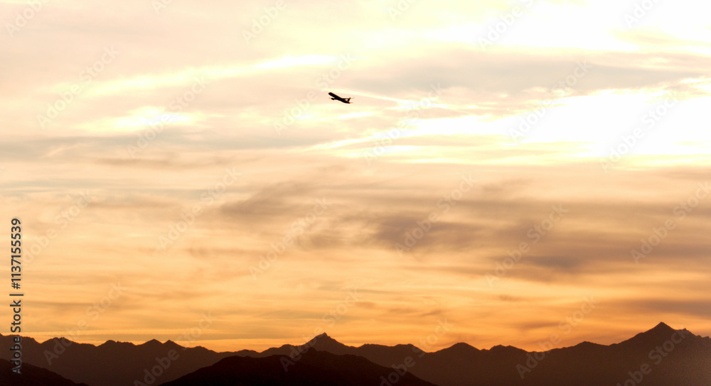 Airplane in the desert sky at golden hour Airplane in the desert sky at golden hour