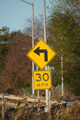 turn left and crossing sign on blue sky