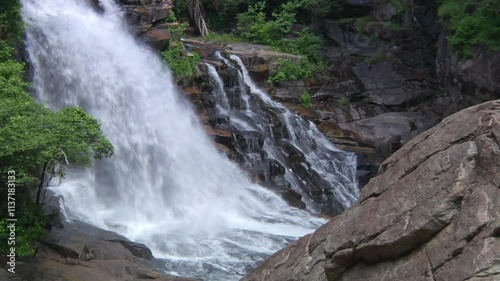Telephoto shot of a waterfall past boulders at Tallulah Gorge State Park, Georgia