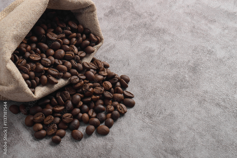 Coffee beans in bag isolated on dark cement background Coffee beans in bag isolated on dark cement background