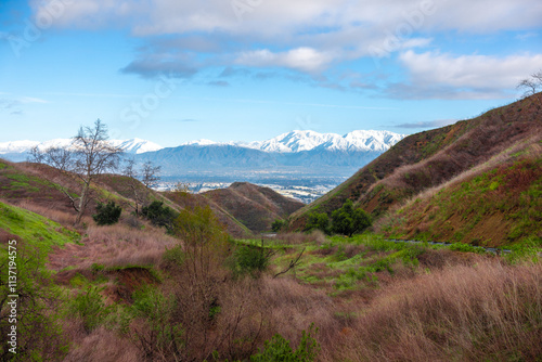 View over Chino Hills / Inland Empire in California with snowy mountains in the background. Visible are Ontario Peak, Mount Baldy and other San Bernardino mountains. 