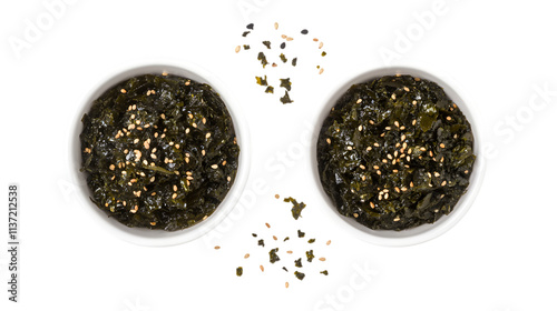 Top and side view of fresh seaweed salad sprinkled with sesame seeds, served in white bowls, isolated on a white background ideal for health-conscious and vegan cuisine.