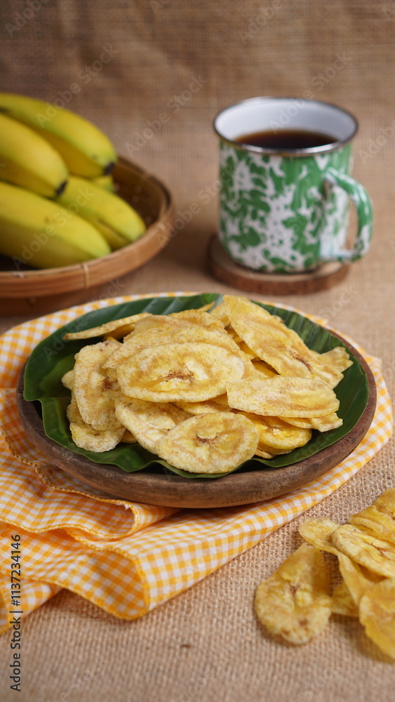 Indonesian banana chips on a wooden bowl with a traditional property theme photographed with studio light Indonesian banana chips on a wooden bowl with a traditional property theme photographed with studio light