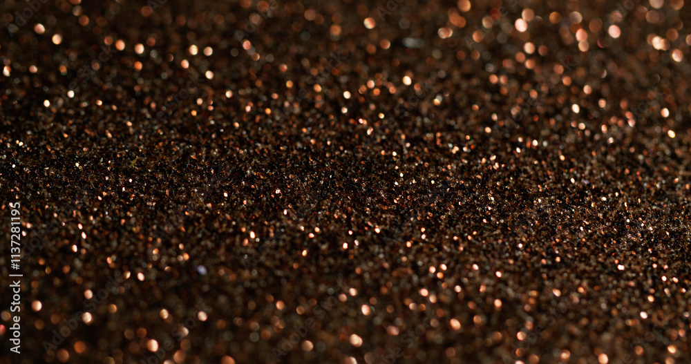 Bokeh powder. Golden glitter. Fading shimmering festive surface with fine metallic dust. Color precious shining glamour blur particles. Bokeh powder. Golden glitter. Fading shimmering festive surface with fine metallic dust. Color precious shining glamour blur particles.