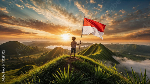 A child on a hill watching the sunrise with a fluttering Indonesian flag. photo