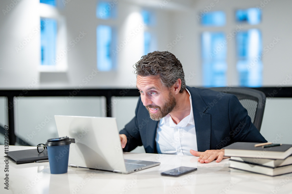 Angry Office worker with laptop at office. Ofice employee remote working in modern office. Businessman on remote meeting, working online in offices place. Business man using computer in office. Angry Office worker with laptop at office. Ofice employee remote working in modern office. Businessman on remote meeting, working online in offices place. Business man using computer in office.
