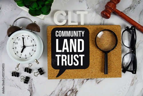 Bild auf Leinwand CLT - Community Land Trust acronym with alarm clock and magnifying glass, commun