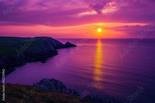 Serene sunset over a calm sea, casting purple hues on the landscape.