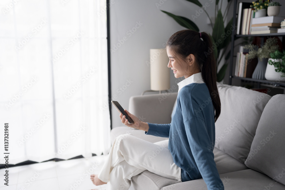 Asian woman using voice assistant on smartphone at home conversation with online assistant Voice chat bot conversational AI Modern Technologies Asian woman using voice assistant on smartphone at home conversation with online assistant Voice chat bot conversational AI Modern Technologies