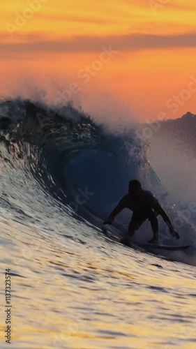 Video of young adult surfs in ocean at evening time