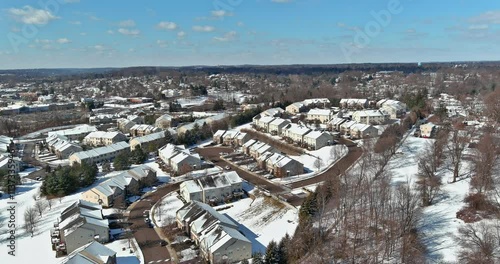 Aerial view of American town peaceful suburban area blanketed in snow, with houses at Pennsylvania USA