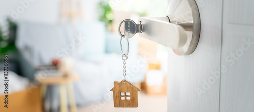 Moving house, relocation. The key was inserted into the door of the new house, inside the room was a cardboard box containing personal belongings and furniture. move in the apartment or condominium.