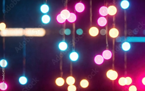 Colorful bokeh lights create a festive and vibrant atmosphere.