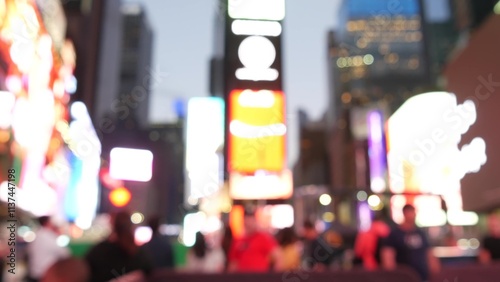 New York City Times Square, Manhattan Midtown Broadway street, USA. American NYC urban life. Defocused people pedestrians. Advertising signs, commercial ads, illuminated billboard screens glowing.