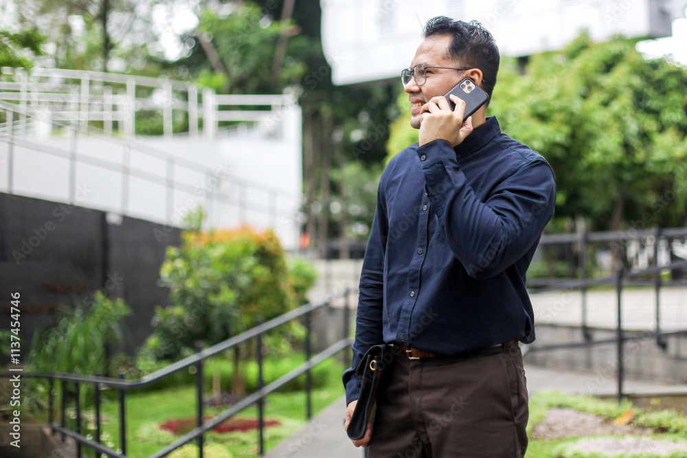 Man In Formal Suit Calling Using Mobile Phone While Standing on Park Man In Formal Suit Calling Using Mobile Phone While Standing on Park