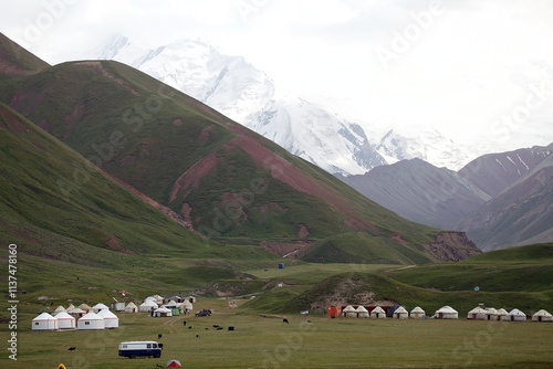 Yurt camp at Tulpar Kul Lake at the foot of Lenin Peak in the Pamir Mountains in Kyrgyzstan photo