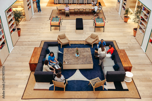 Overhead view of modern office lounge with people engaging in conversation photo