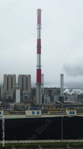 Slow motion, Industrial landscape, energy extraction from coal, thermal power station, view from height of the pipes in the fog, environmental issues, vertical video.