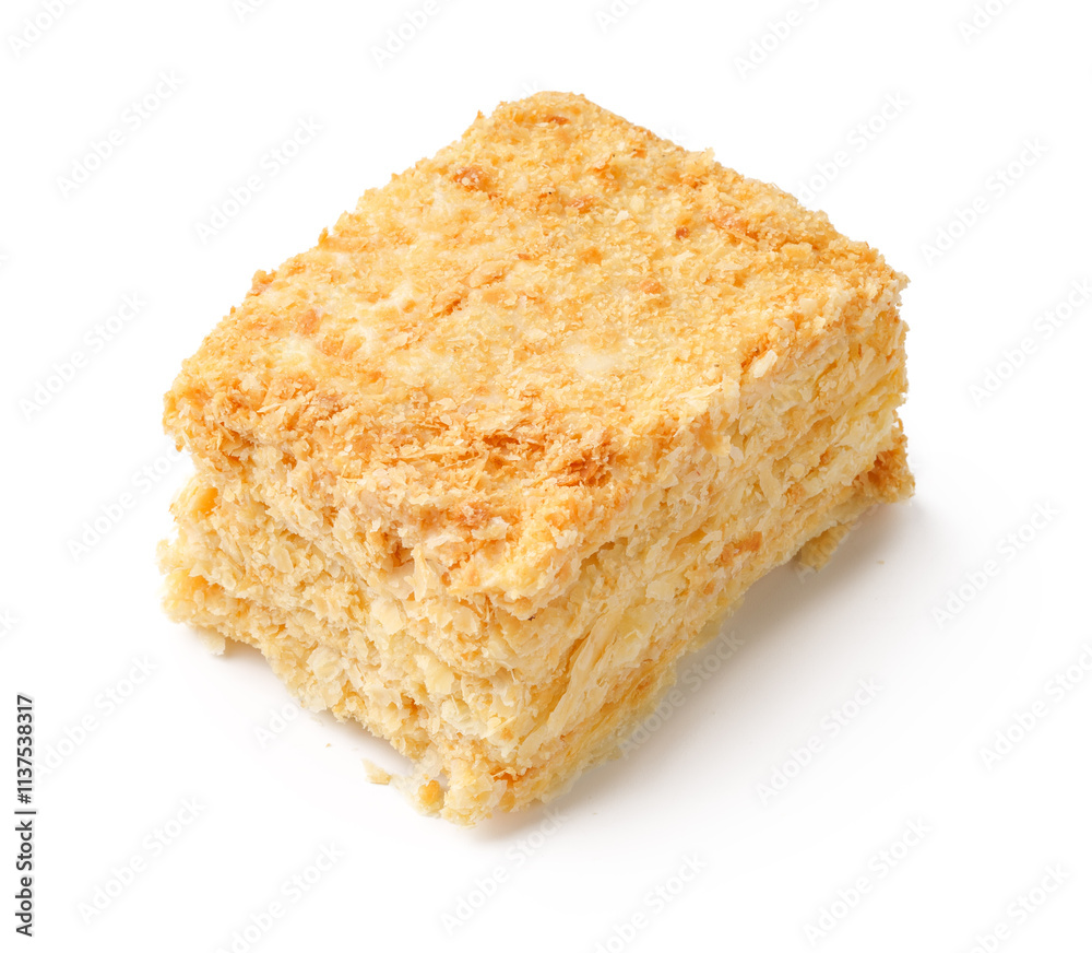 Delicious square of layered dessert made from cream, sugar, and flaky pastry enjoyed in a cozy cafe setting Delicious square of layered dessert made from cream, sugar, and flaky pastry enjoyed in a cozy cafe setting