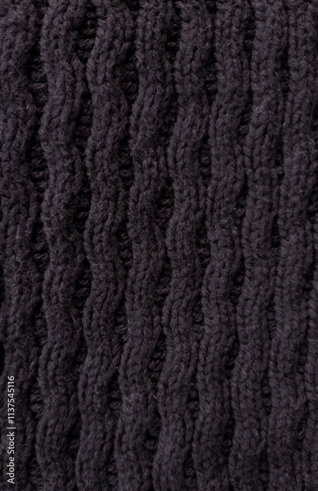 black Wool fabric photographed close-up in a special design. Texture stands out with material. Clothing background sweater black Wool fabric photographed close-up in a special design. Texture stands out with material. Clothing background sweater