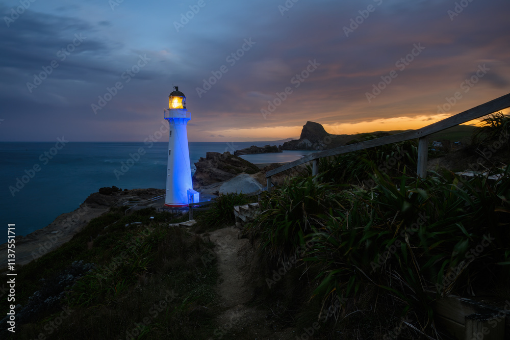 Castlepoint lighthouse lights up in blue at night. Wairarapa. New Zealand.