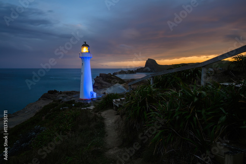 Obraz na płótnie Castlepoint lighthouse lights up in blue at night. Wairarapa. New Zealand. w salonie