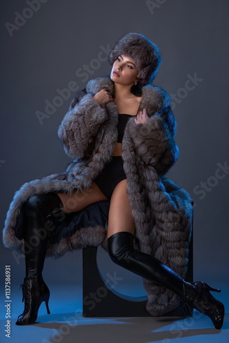 slender brunette girl in a long blue fur coat and hat