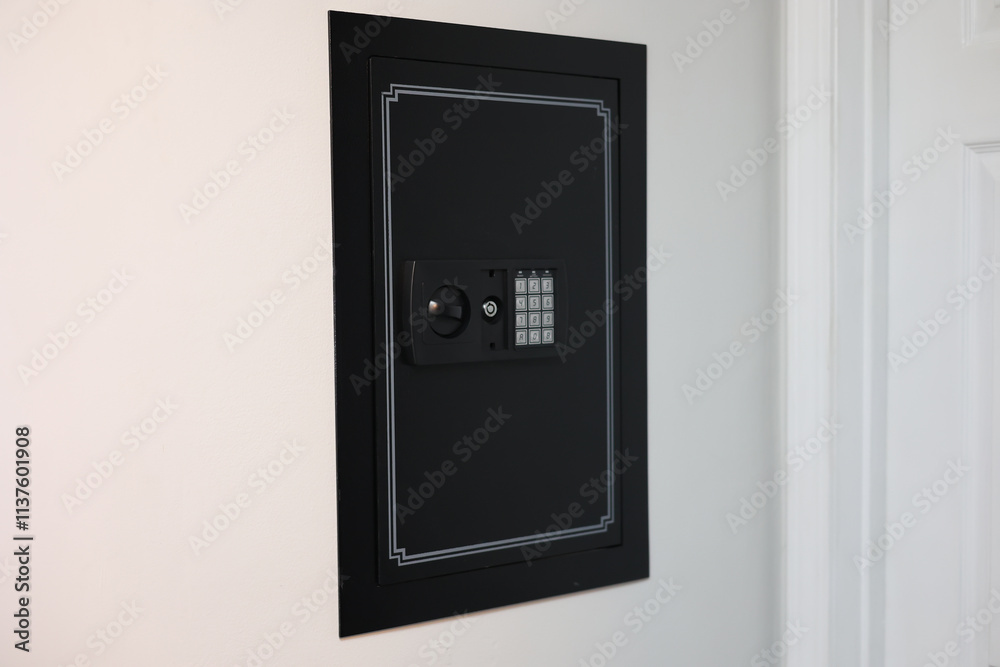 A close-up of a hidden in-wall safe discreetly installed within a wall. The sleek design emphasizes security and practicality for safeguarding valuables. A close-up of a hidden in-wall safe discreetly installed within a wall. The sleek design emphasizes security and practicality for safeguarding valuables.