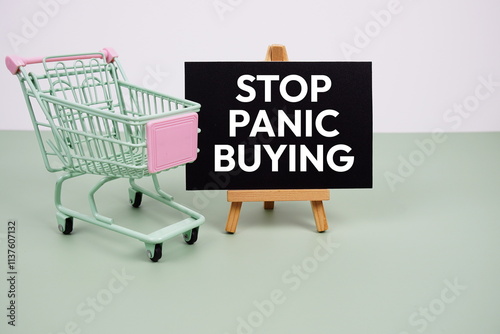 Stop Panic Buying text message and trolley shopping cart on green background photo