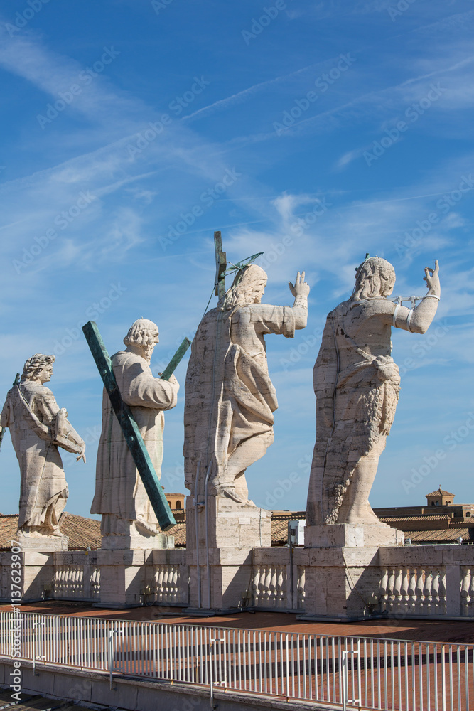 Fototapeta premium Figure of Jesus and apastols on the top of the facade of Saint Peter's Basilica, Vatican, Rome, Italy