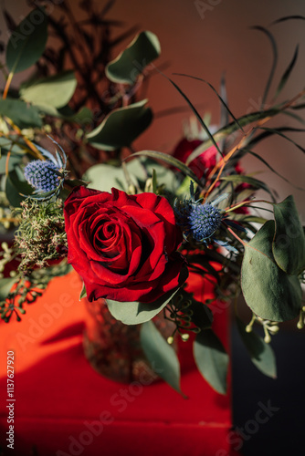 Fototapeta Naklejka Na Ścianę i Meble -  red rose in bouquet, arrangement with eucalyptus and Mediterranean sea holly