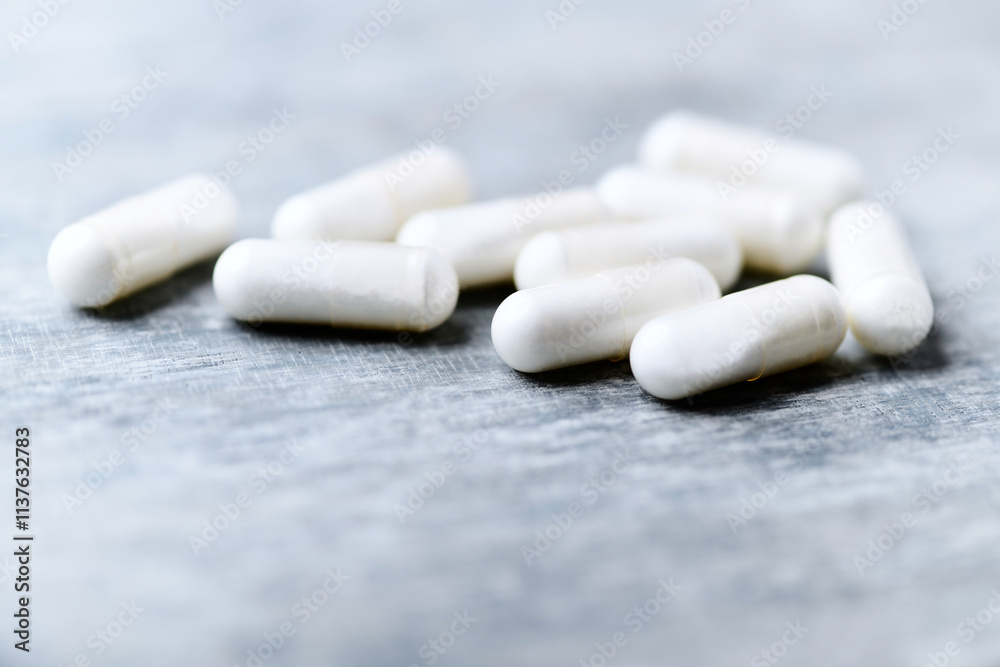 Beta-alanine capsules. Bodybuilding food supplements on wooden background. Soft focus. Close up. Copy space. Beta-alanine capsules. Bodybuilding food supplements on wooden background. Soft focus. Close up. Copy space.