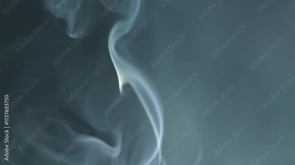 Mysterious wisps of smoke dance in the air creating an enchanting atmosphere in a dimly lit room Mysterious wisps of smoke dance in the air creating an enchanting atmosphere in a dimly lit room