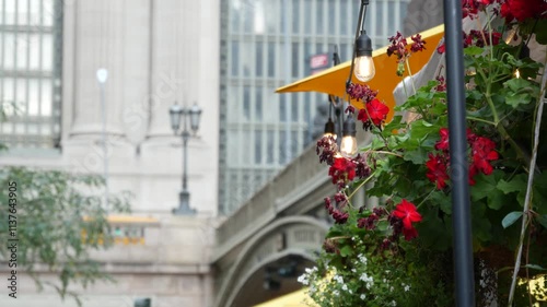 New York City Grand Central Terminal railway station, 42 street. Manhattan Midtown. Bridge on Pershing Square, NYC, USA. American urban scene, United States. Light bulb garland, umbrellas and flowers.