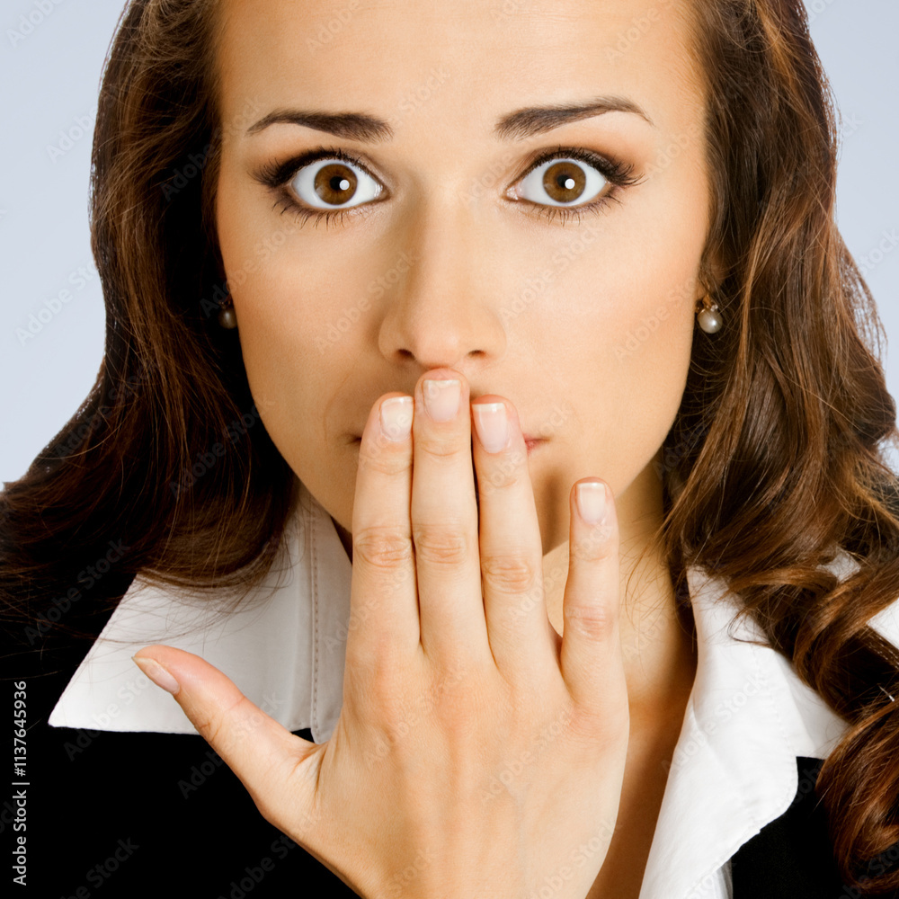 Wow! Expressive surprised, astonished shocked businesswoman keep hand over face. Amazed corporate business woman covering mouth with palm, isolated gray grey background. Wow! Expressive surprised, astonished shocked businesswoman keep hand over face. Amazed corporate business woman covering mouth with palm, isolated gray grey background.