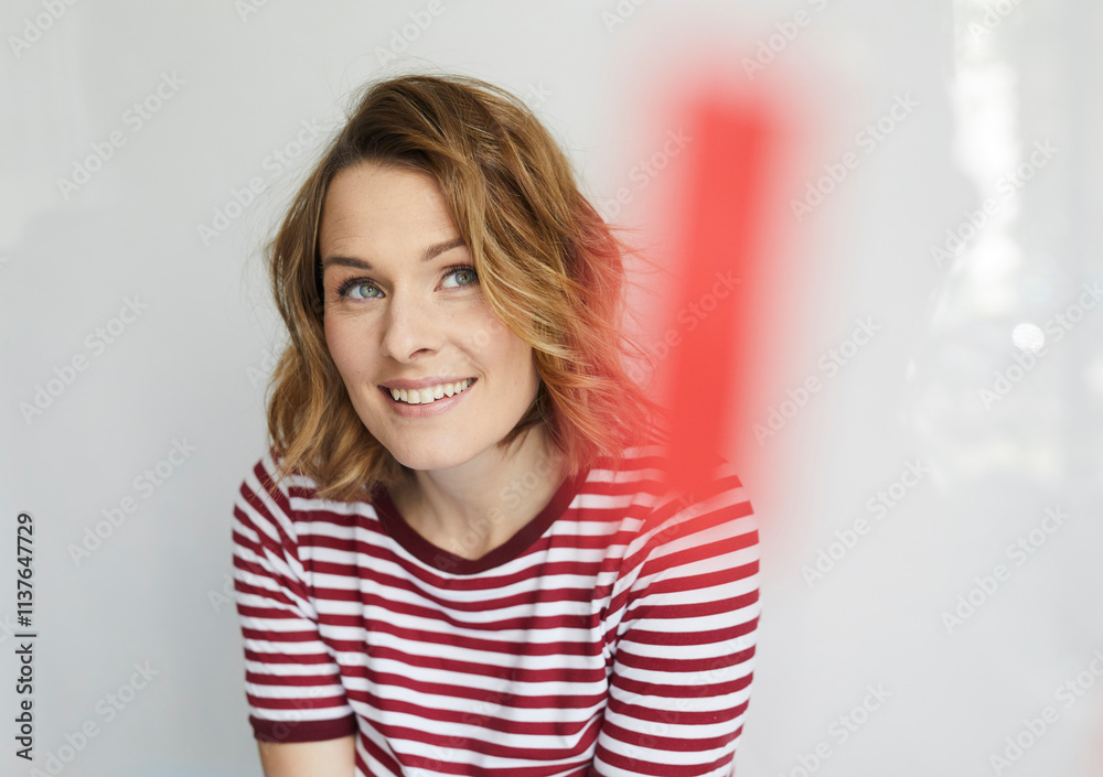 Portrait of smiling woman wearing red-white striped t-shirt Portrait of smiling woman wearing red-white striped t-shirt