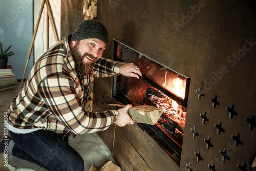 Portrait of bearded man kneeling in front of fireplace at home photo