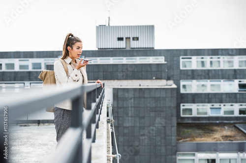 Young businesswoman using smartphone in he city photo